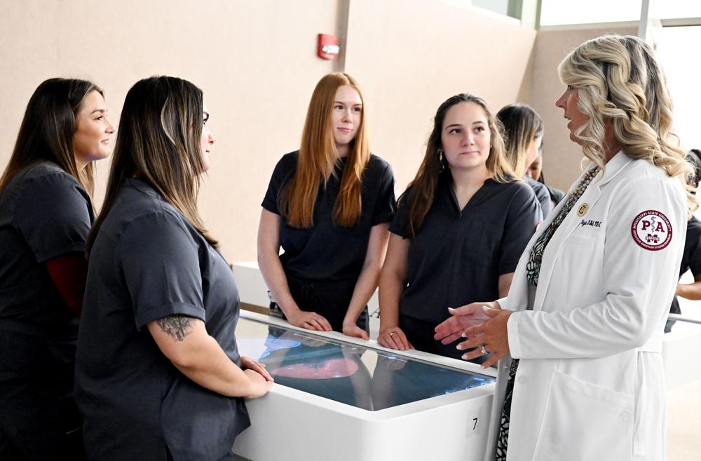 Mississippi State Master of Physician Assistant Studies students in the School of Health Professions, from left, Mary Catherine Comeaux of Port Allen, Louisiana, Ruth Boquet of Houma, Louisiana, Riley Jackson of Biloxi and Maybri Eldridge of Dothan, Alabama, work in the Anatomage lab at MSU-Meridian with Pam Vayda, department head and program director, right. Once students have completed the didactic phase of their education, they will move to clinicals with preceptors funded in part by the new grant.