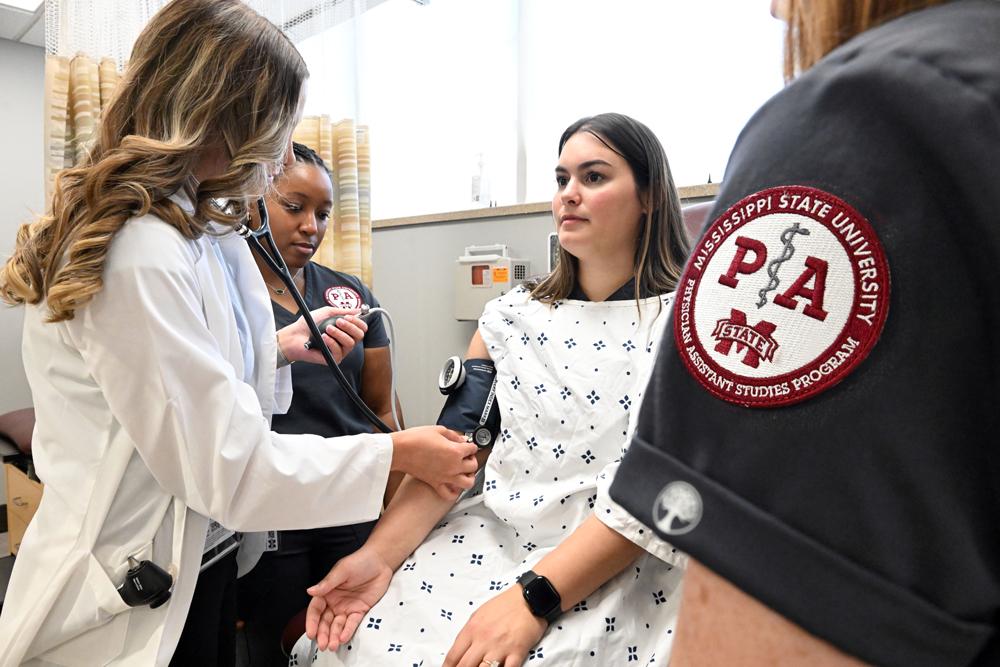 Mississippi State Master of Physician Assistant Studies students in the School of Health Professions, from left, Elise Latiolas of New Orleans, Louisiana, JaMya Hopson of Madison and Ruth Boquet of Houma, Louisiana, practice blood pressure labs at MSU-Meridian. (Photo by Marianne Todd)
